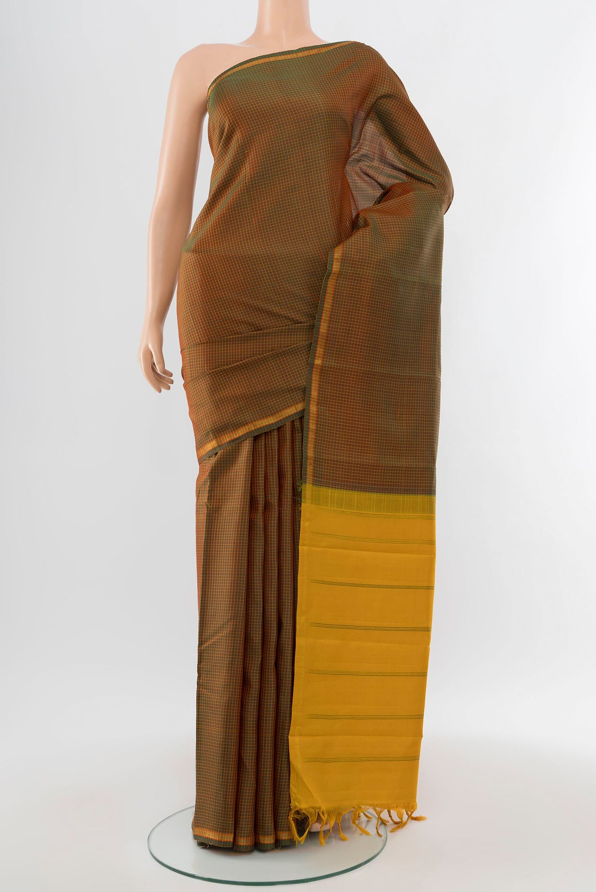 Pure Silk Pure Zari Mehandi Green Kanjivaram Saree with Zari Butta on the body and Silk Border.  displayed on a mannequin