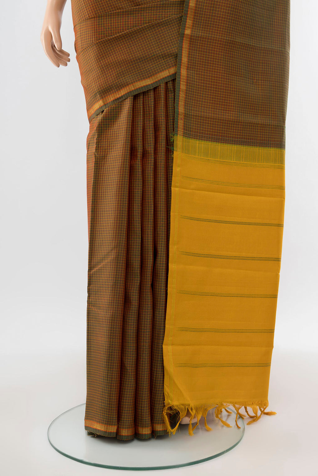 Pleats and pallu of Pure Silk Pure Zari Mehandi Green Kanjivaram Saree with Zari Butta on the body and Silk Border. 