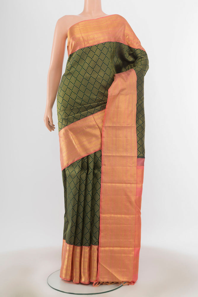 Bottle Green Kanchipuram Silk Saree with Zari Butta on the body and Silk Border.  displayed on a mannequin