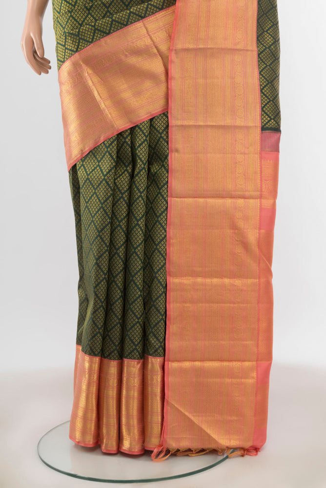 Pleats and pallu of Bottle Green Kanchipuram Silk Saree with Zari Butta on the body and Silk Border. 