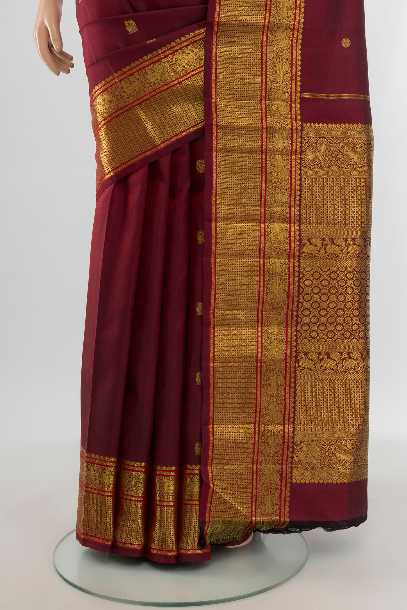 Pleats and pallu of Pure Silk Pure Zari Maroon Kanchipuram Saree with Zari Butta on the body and Zari Border. 