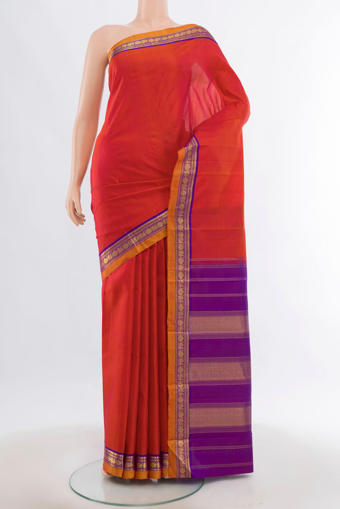 Peach Kanjivaram Silk Saree with Zari Butta on the body and Silk Border.  displayed on a mannequin