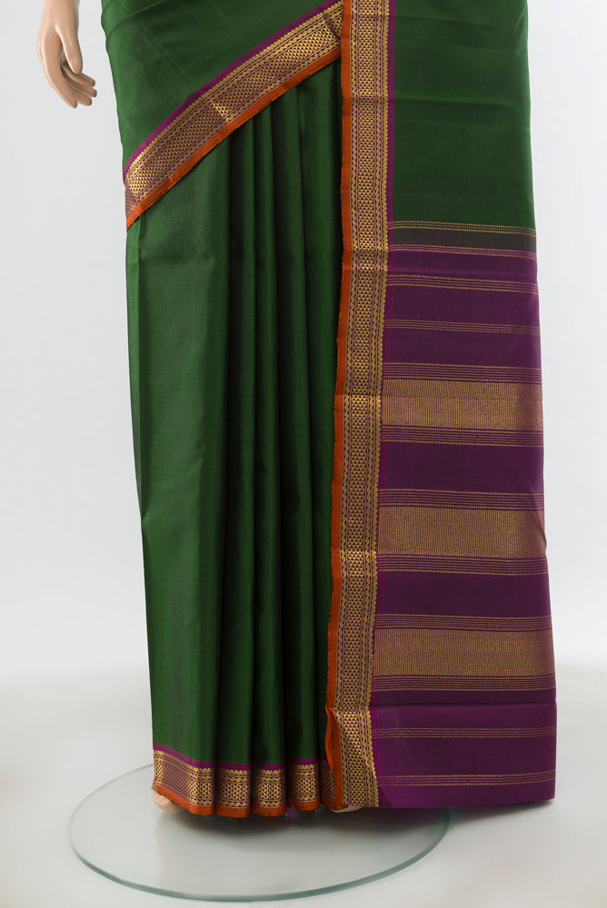 Pleats and pallu of Pure Silk Pure Zari Bottle Green Kanjivaram Saree with Zari Butta on the body and Silk Border. 
