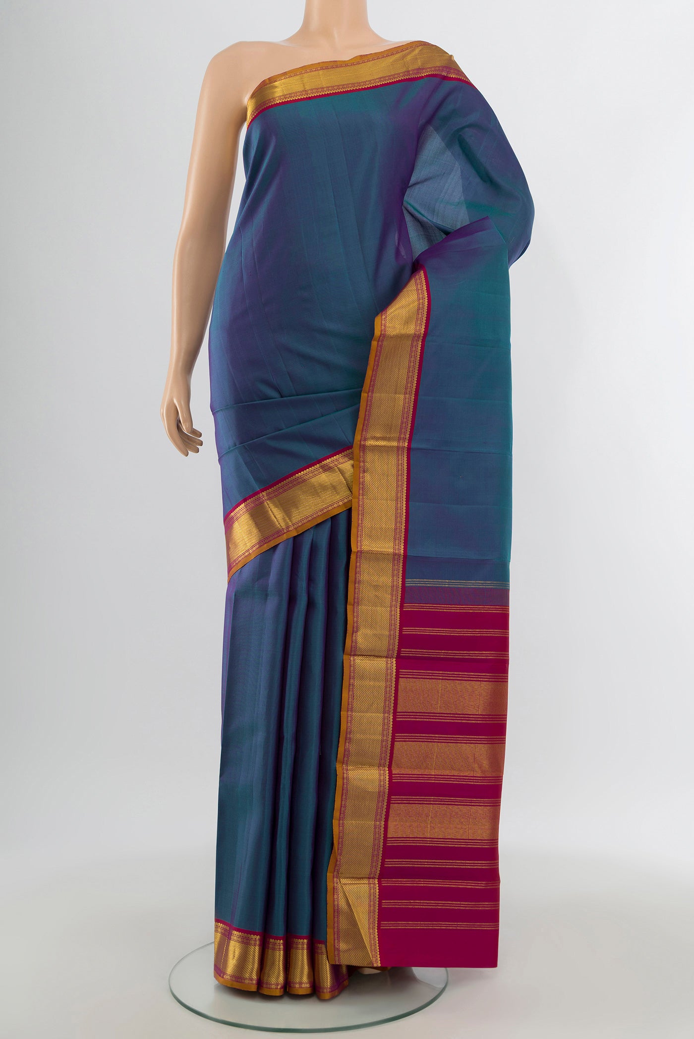 Multi Color Kanchipuram Silk Saree with Plain Body and Zari Border.  displayed on a mannequin