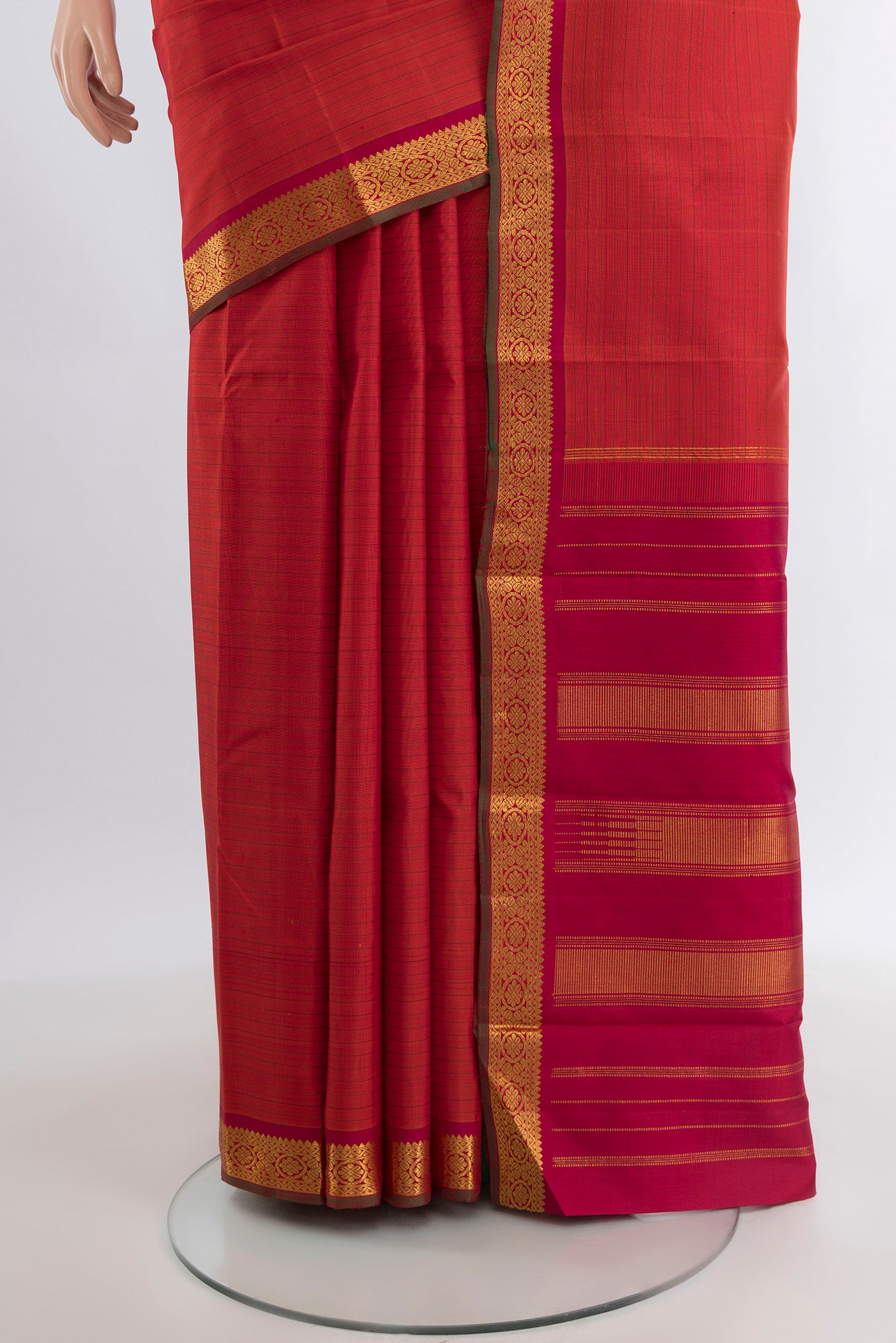 Pleats and pallu of Brick Orange Kanchipuram Silk Saree with Stripes on the body and Zari Border. 