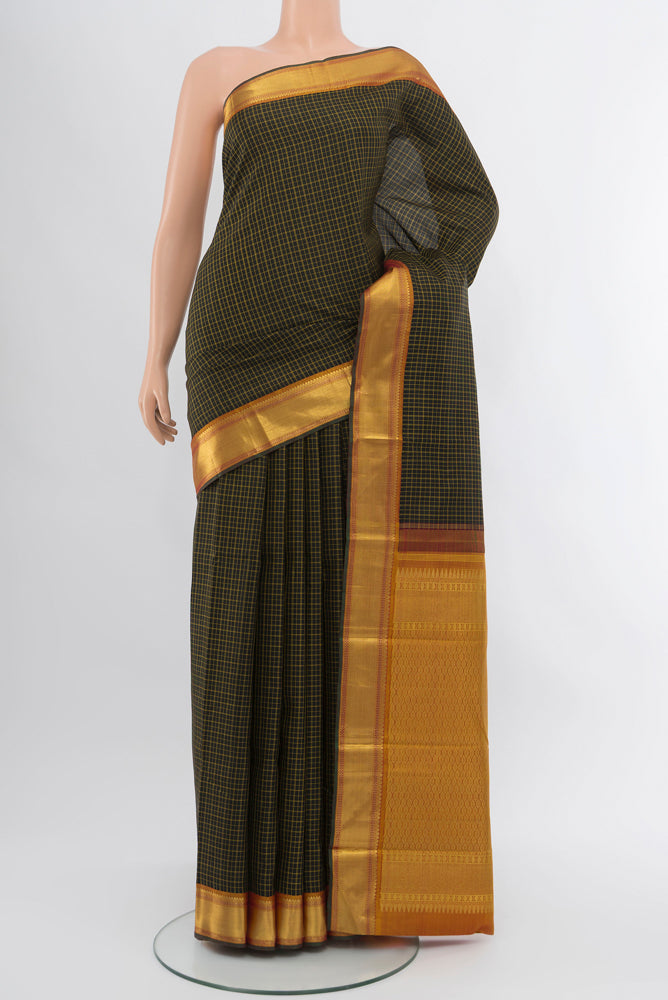 Black Kanjivaram Silk Saree with Zari Butta on the body and Silk Border.  displayed on a mannequin