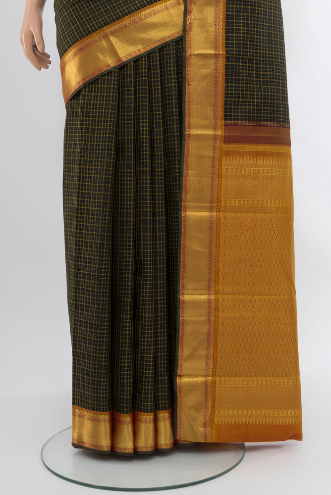 Pleats and pallu of Black Kanjivaram Silk Saree with Zari Butta on the body and Silk Border. 