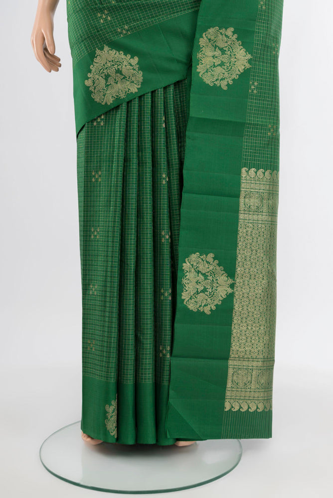Pleats and pallu of Bottle Green Kanjivaram Silk Saree with Zari Butta on the body and Silk Border. 