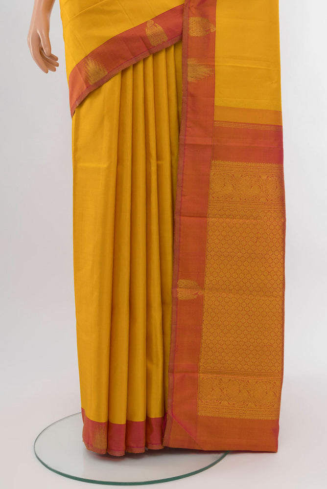 Pleats and pallu of Mustard Kanjivaram Silk Saree with Zari Brocade on the body and Silk Border. 