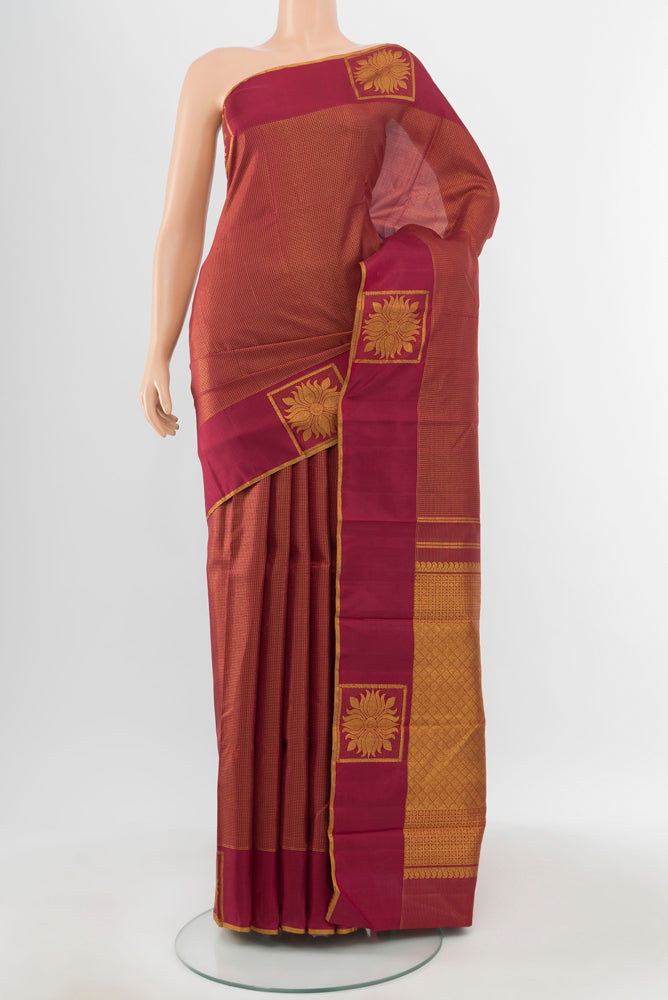 Pure Silk Pure Zari Maroon Kanjivaram Saree with Zari Butta on the body and Silk Border.  displayed on a mannequin