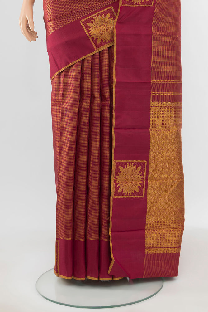 Pleats and pallu of Pure Silk Pure Zari Maroon Kanjivaram Saree with Zari Butta on the body and Silk Border. 