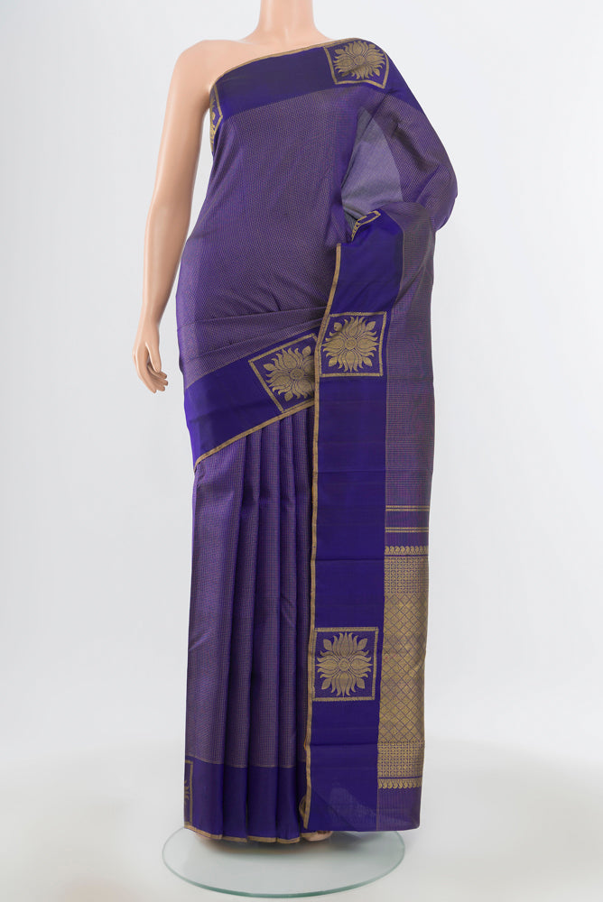 Pure Silk Pure Zari Violet Kanjivaram Saree with Zari Butta on the body and Silk Border.  displayed on a mannequin
