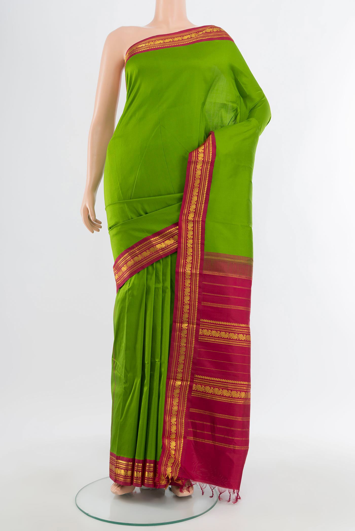 Pure Silk Pure Zari Parrot Green Kanjivaram Saree with Zari Butta on the body and Zari Border.  displayed on a mannequin