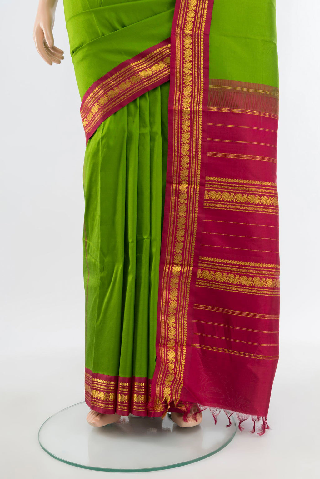 Pleats and pallu of Pure Silk Pure Zari Parrot Green Kanjivaram Saree with Zari Butta on the body and Zari Border. 