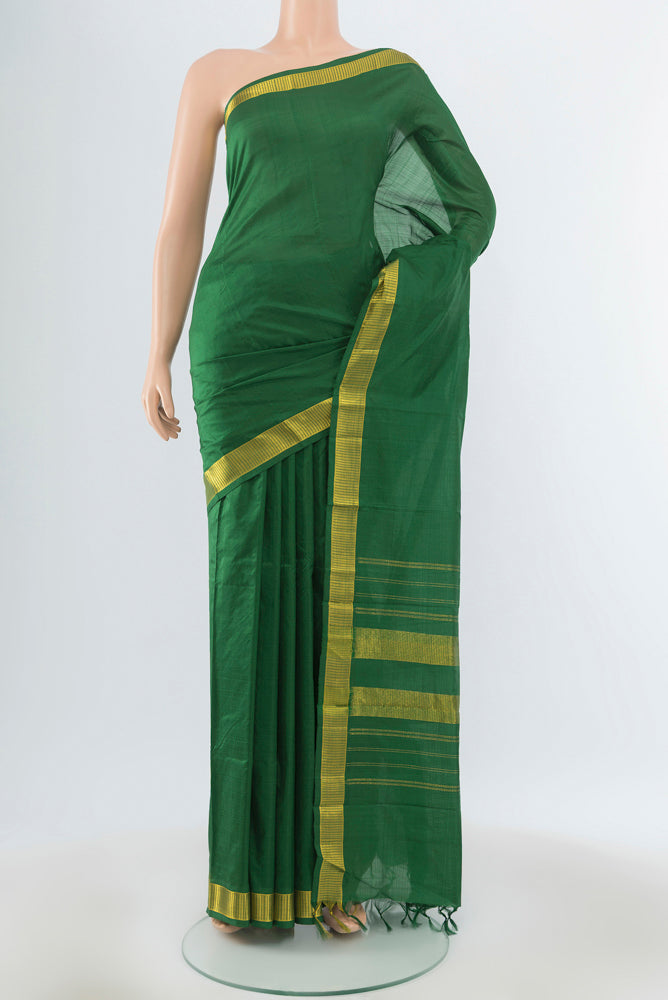 Bottle Green Kanjivaram Silk Saree with Plain Body and Silk Border.  displayed on a mannequin