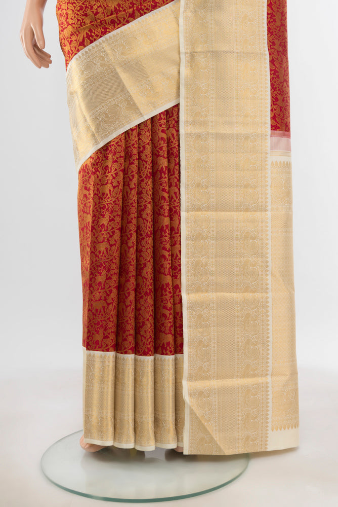 Pleats and pallu of Pure Silk Pure Zari Maroon Kanchipuram Saree with Zari Butta on the body and Silk Border. 
