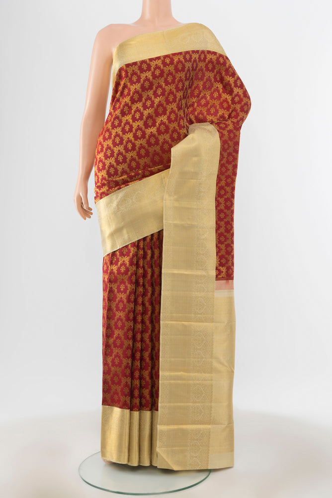 Maroon Kanchipuram Silk Saree with Zari Brocade on the body and Silk Border.  displayed on a mannequin