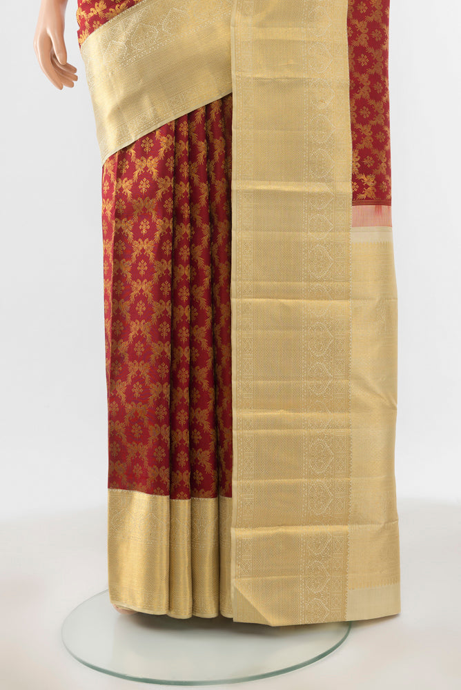 Pleats and pallu of Maroon Kanchipuram Silk Saree with Zari Brocade on the body and Silk Border. 