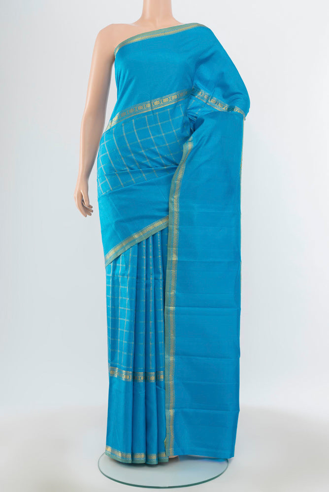 Pure Silk Pure Zari Light Blue Kanchipuram Saree with Zari Butta on the body and Silk Border.  displayed on a mannequin