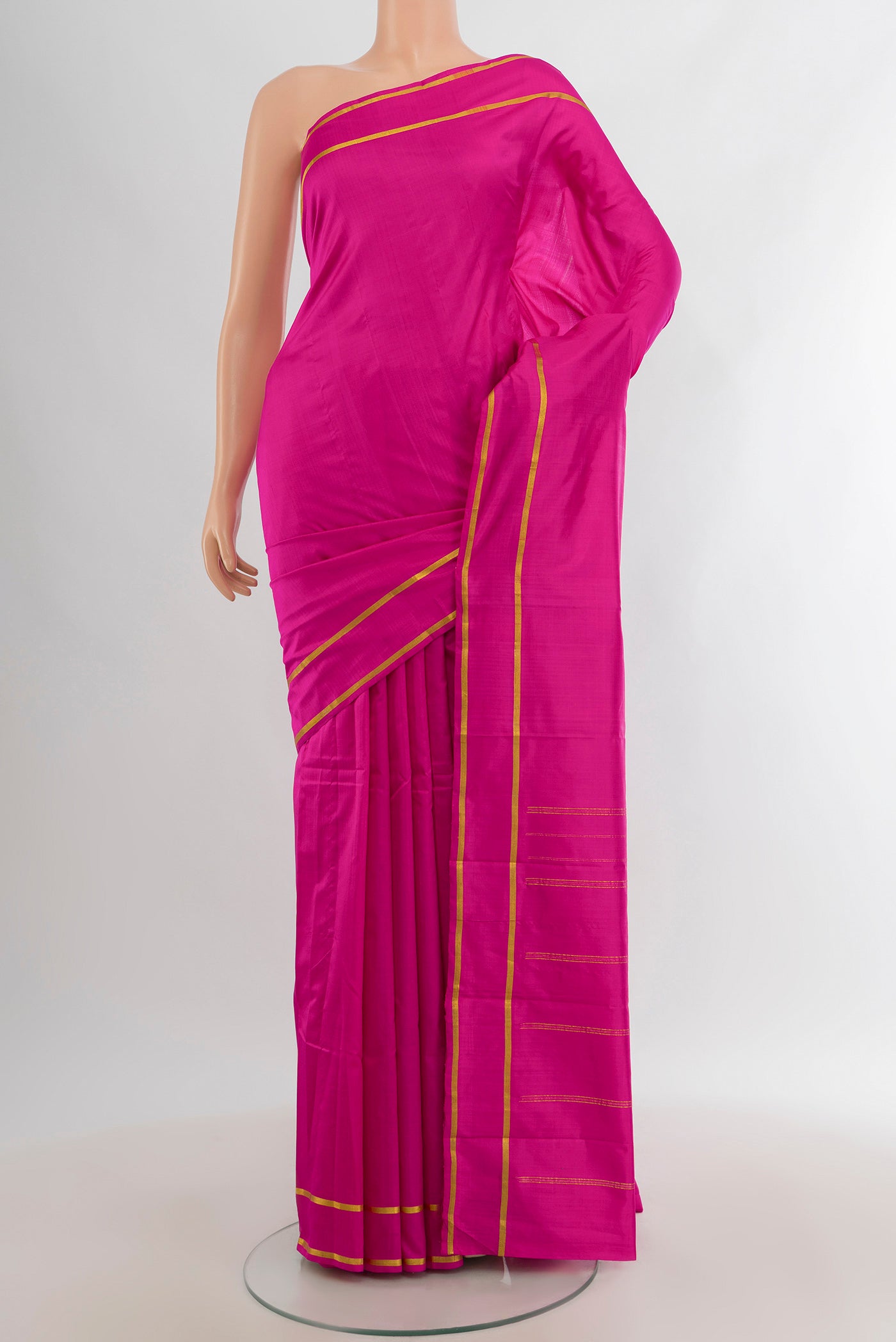 Magenta Kanjivaram Silk Saree with Plain Body and Zari Border.  displayed on a mannequin