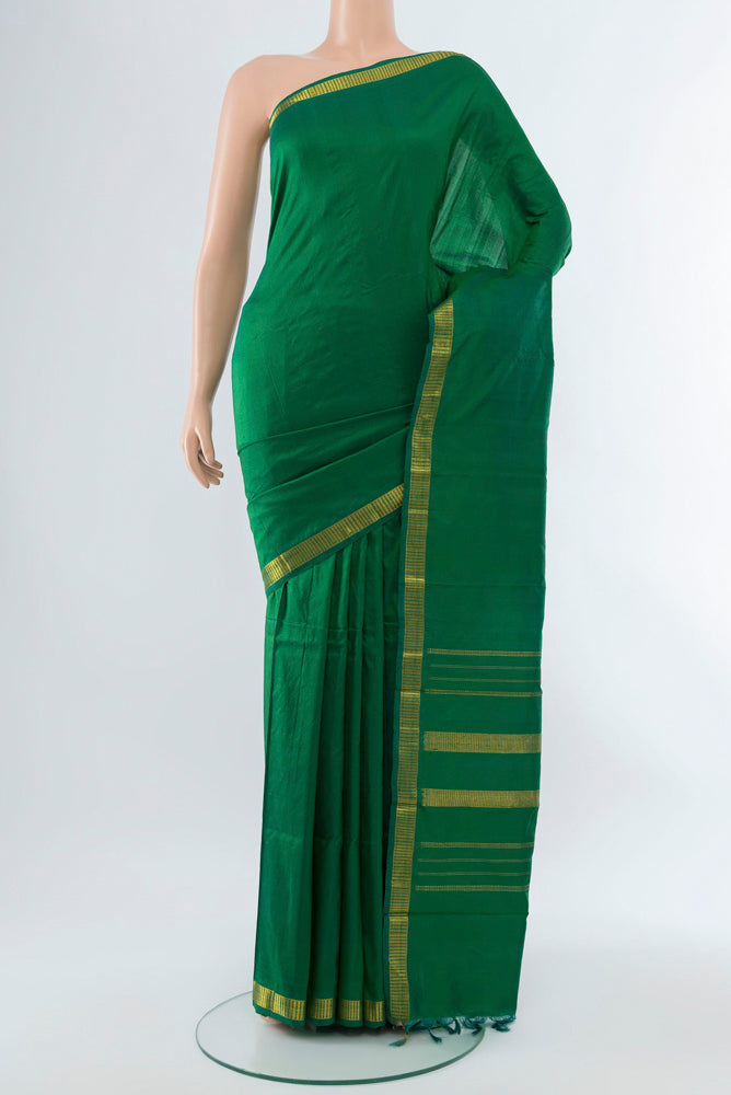 Light Green Kanchipuram Silk Saree with Plain Body and Silk Border.  displayed on a mannequin