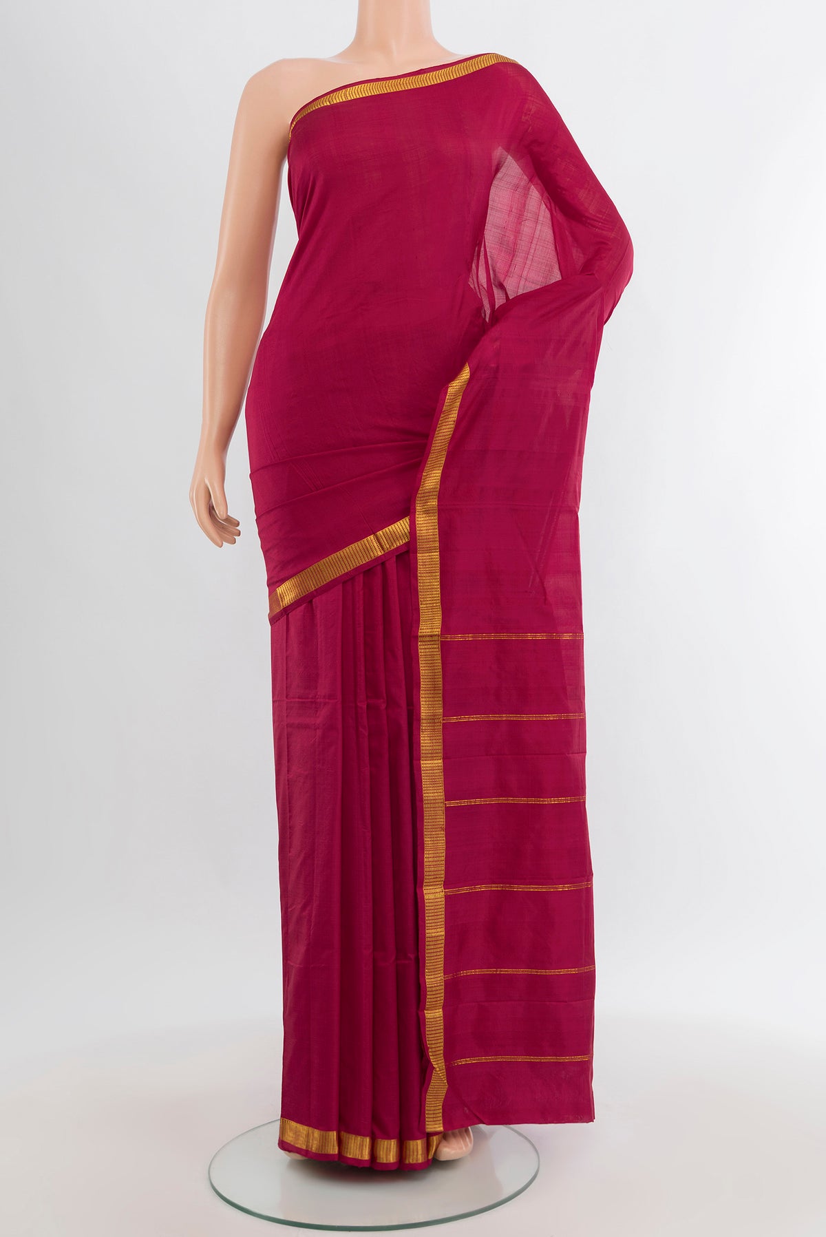 Maroon Kanchipuram Silk Saree with Plain Body and Zari Border.  displayed on a mannequin