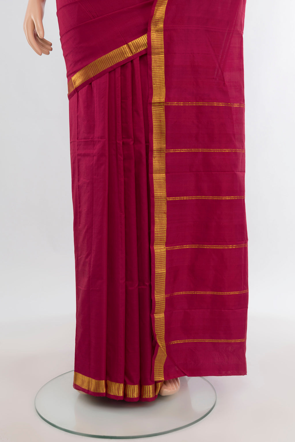 Pleats and pallu of Maroon Kanchipuram Silk Saree with Plain Body and Zari Border. 