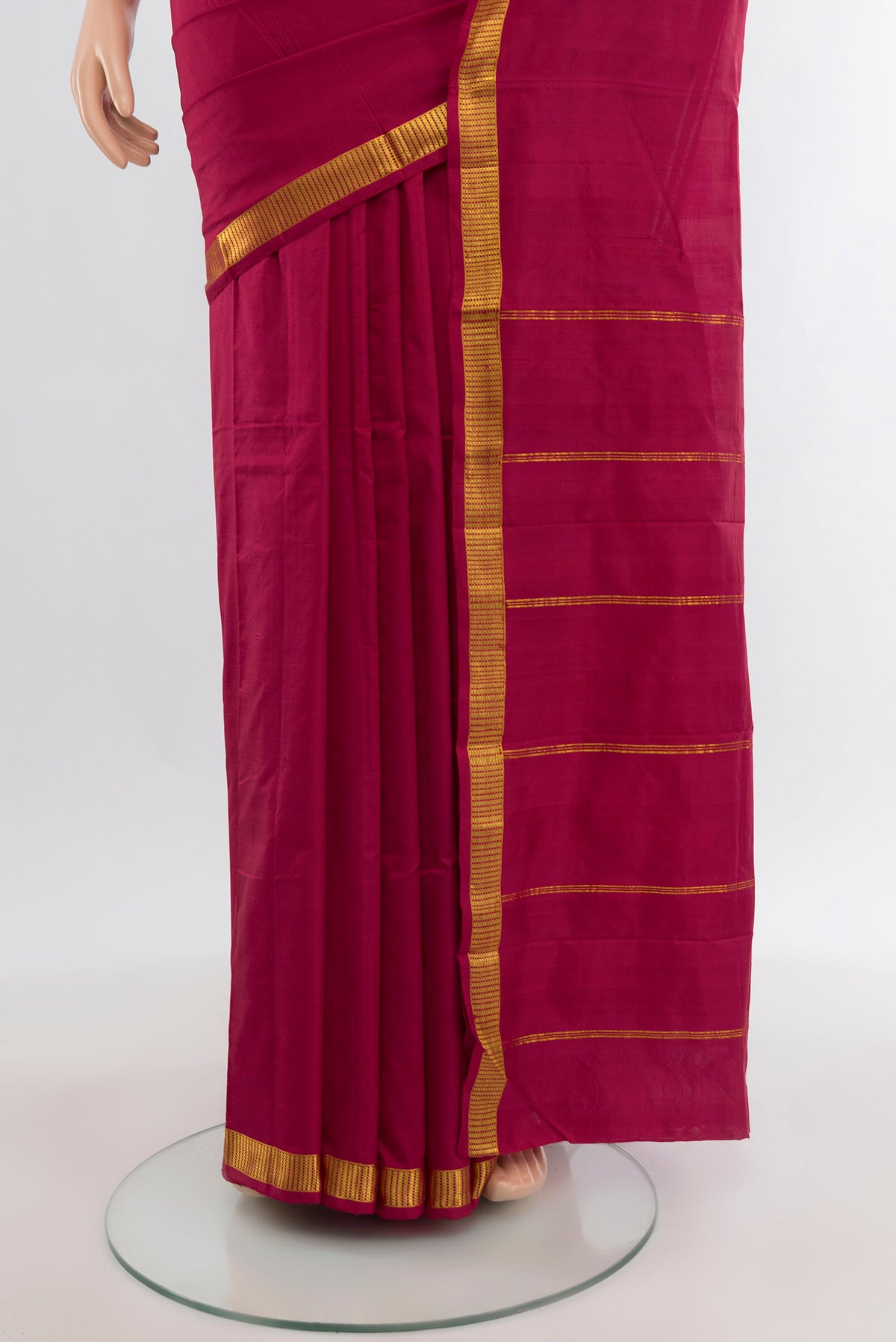 Pleats and pallu of Maroon Kanchipuram Silk Saree with Plain Body and Zari Border. 