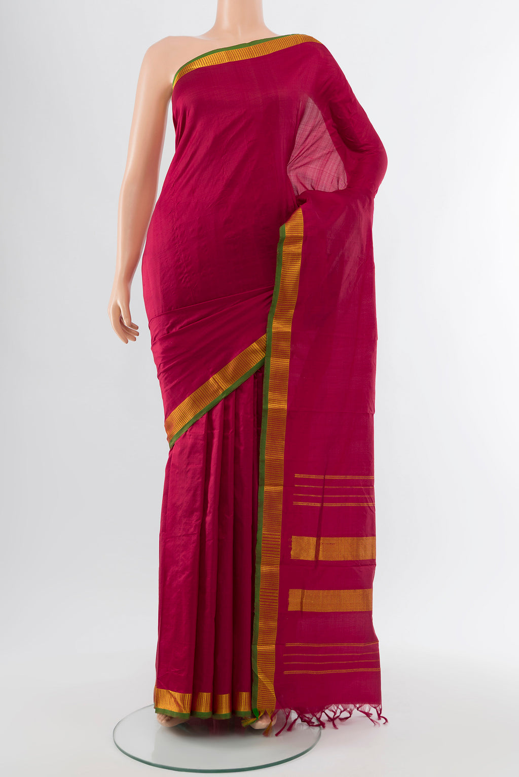 Maroon Kanjivaram Silk Saree with Plain Body and Silk Border.  displayed on a mannequin