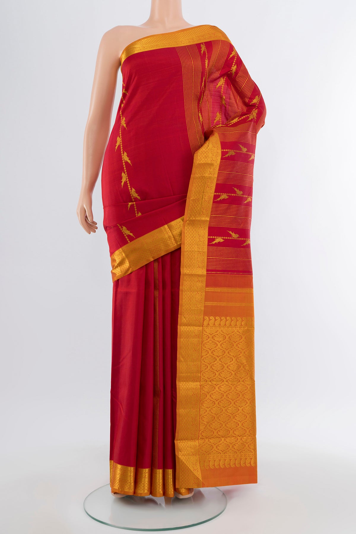 Maroon Kanjivaram Silk Saree with Zari Butta on the body and Silk Border.  displayed on a mannequin