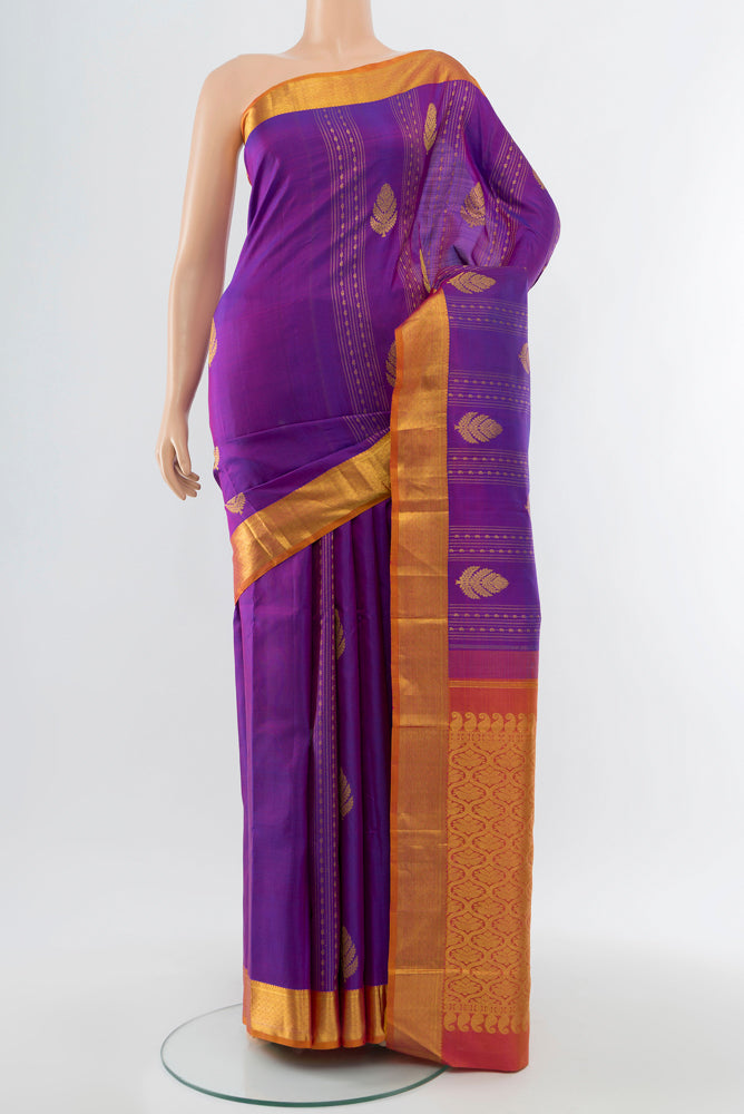 Purple Kanjivaram Silk Saree with Zari Butta on the body and Silk Border.  displayed on a mannequin