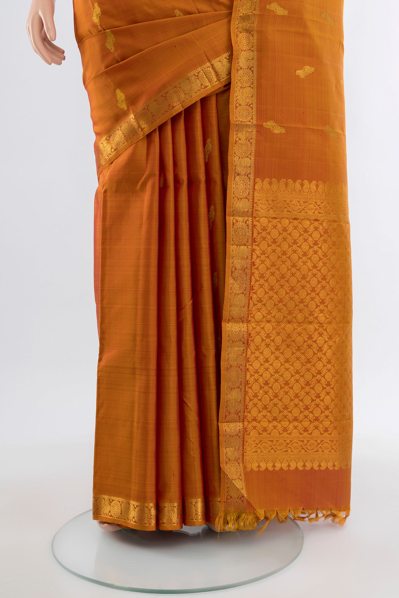 Pleats and pallu of Rust Kanchipuram Silk Saree with Zari Butta on the body and Silk Border. 