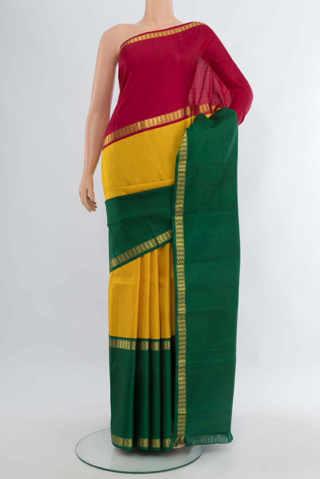 Yellow Kanjivaram Silk Saree with Plain Body and Ganga Jamuna Border.  displayed on a mannequin