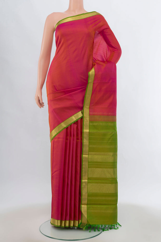 Golden Peach Kanjivaram Silk Saree with Zari Brocade on the body and Silk Border.  displayed on a mannequin