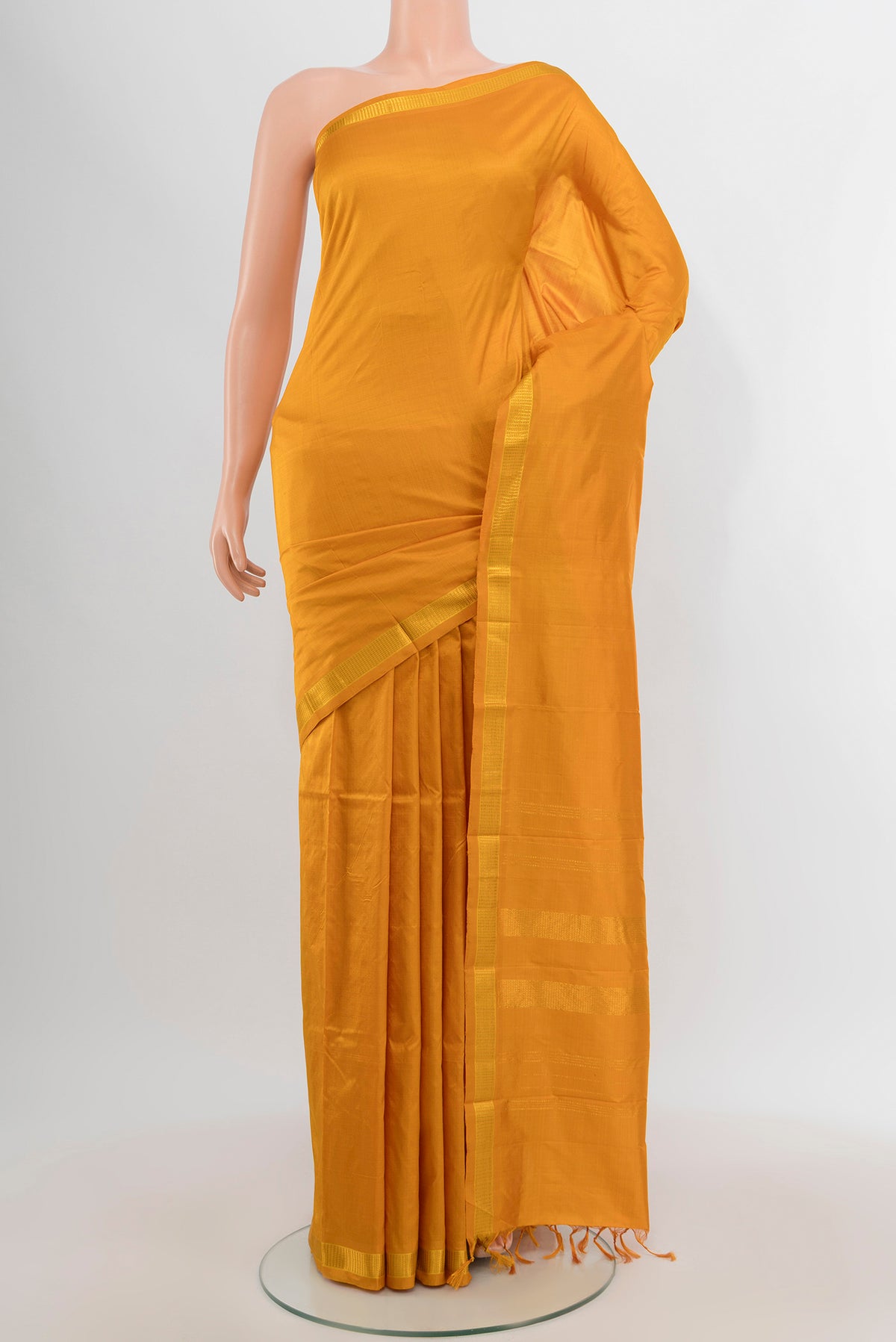 Yellow Kanjivaram Silk Saree with Plain Body and Zari Border.  displayed on a mannequin