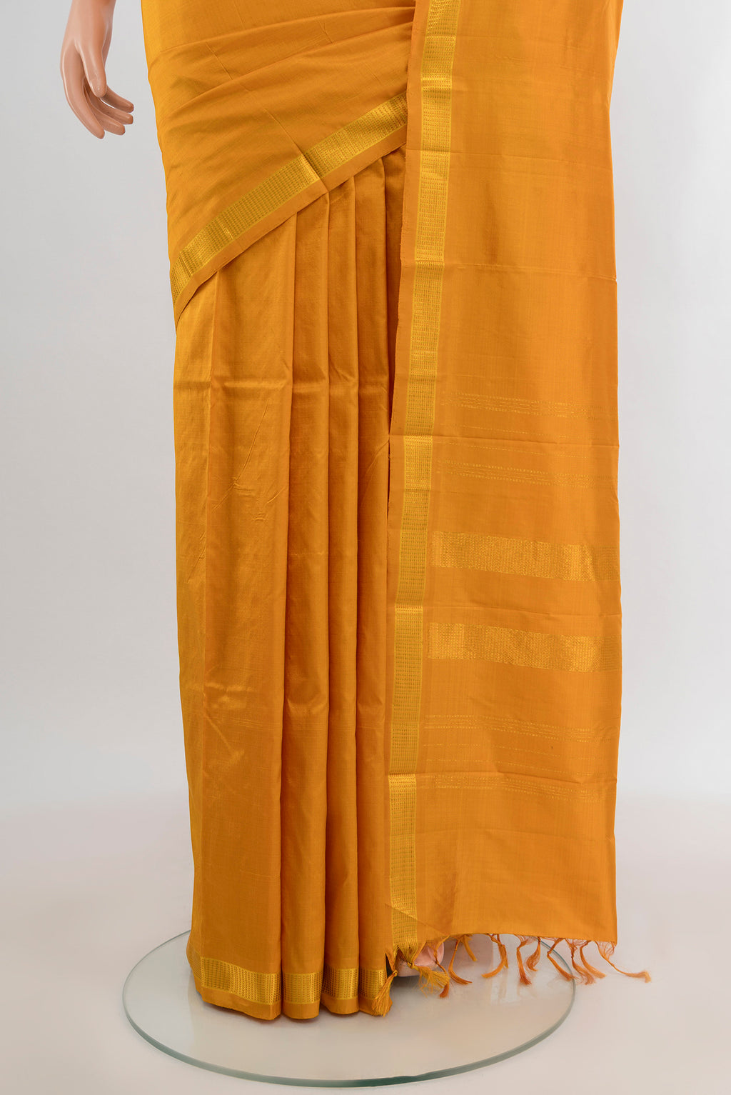 Pleats and pallu of Yellow Kanjivaram Silk Saree with Plain Body and Zari Border. 
