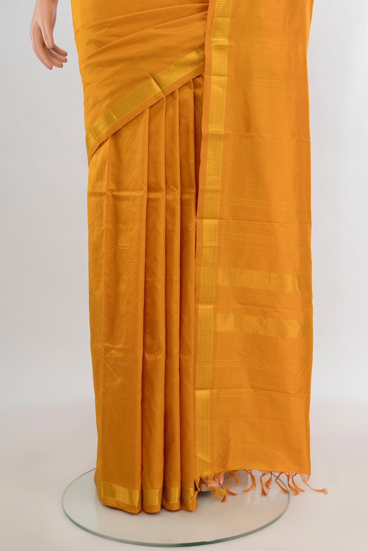 Pleats and pallu of Yellow Kanjivaram Silk Saree with Plain Body and Zari Border. 