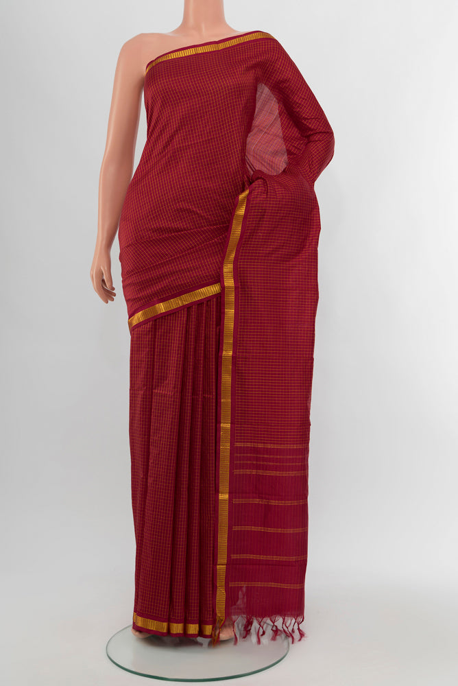 Maroon Kanjivaram Silk Saree with Checked design on the body and Silk Border.  displayed on a mannequin