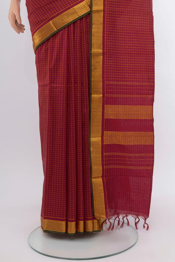 Pleats and pallu of Maroon Kanchipuram Silk Saree with Checked design on the body and Silk Border. 