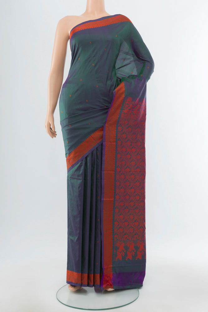 Peacock Blue Kanjivaram Silk Saree with Jacquard With Thread Butta on the body and Silk Border.  displayed on a mannequin
