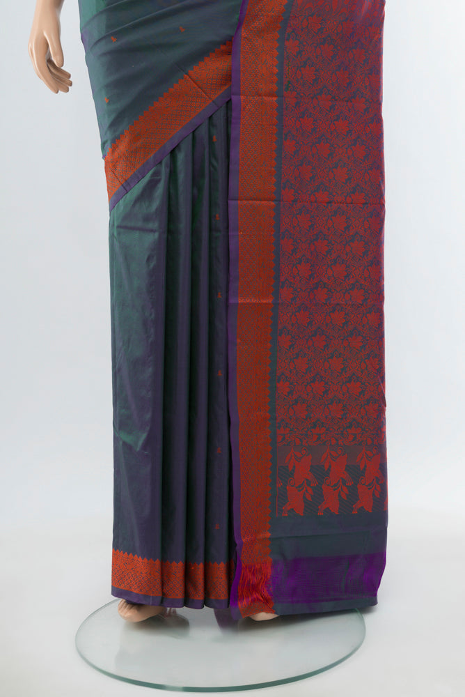 Pleats and pallu of Peacock Blue Kanjivaram Silk Saree with Jacquard With Thread Butta on the body and Silk Border. 
