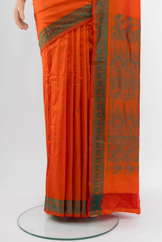 Pleats and pallu of Brick Orange Kanjivaram Silk Saree with Jacquard With Thread Butta on the body and Silk Border. 