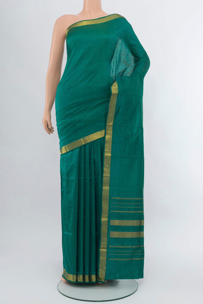 Dark Mauve Kanjivaram Silk Saree with Zari Butta on the body and Silk Border.  displayed on a mannequin