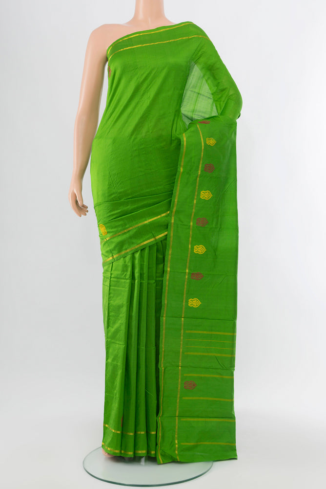Parrot Green Kanchipuram Silk Saree with Zari Butta on the body and Silk Border.  displayed on a mannequin
