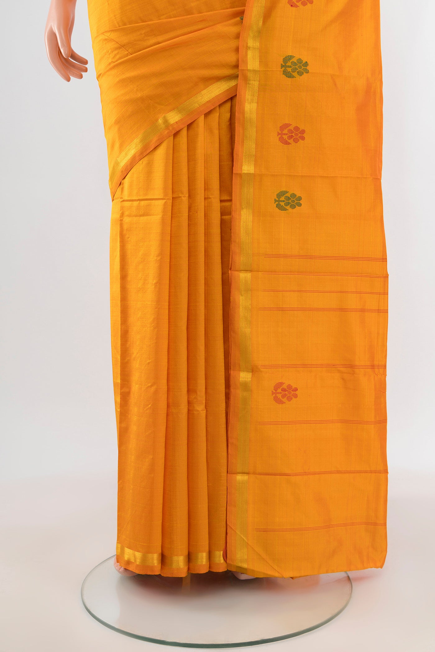 Pleats and pallu of Yellow Kanchipuram Silk Saree with Plain Body and Zari Border. 