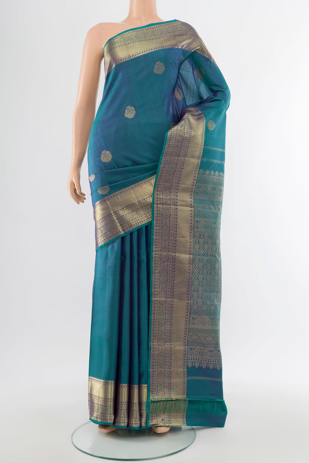 Pure Silk Pure Zari Peacock Blue Kanchipuram Saree with Zari Butta on the body and Silk Border.  displayed on a mannequin