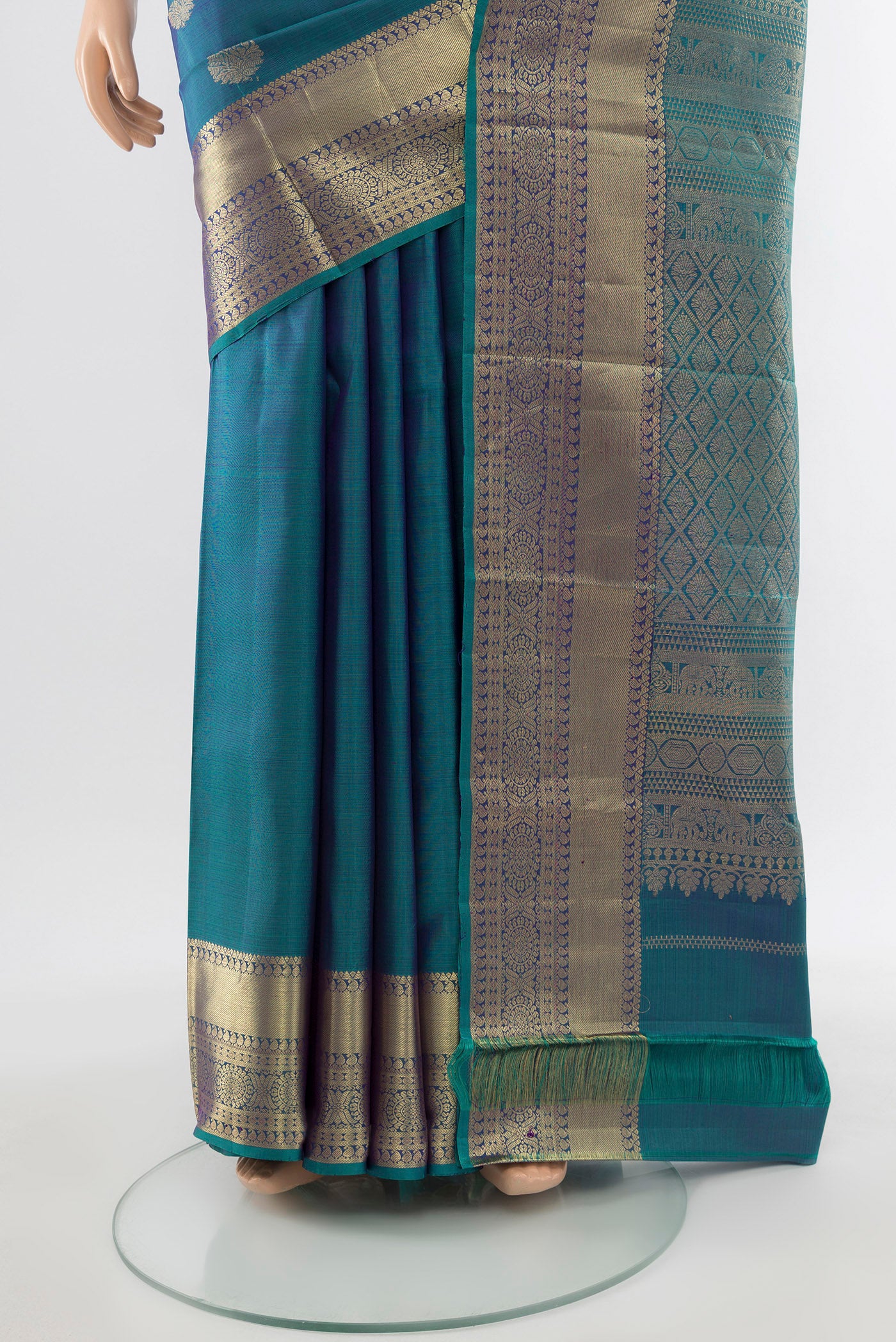 Pleats and pallu of Pure Silk Pure Zari Peacock Blue Kanchipuram Saree with Zari Butta on the body and Silk Border. 
