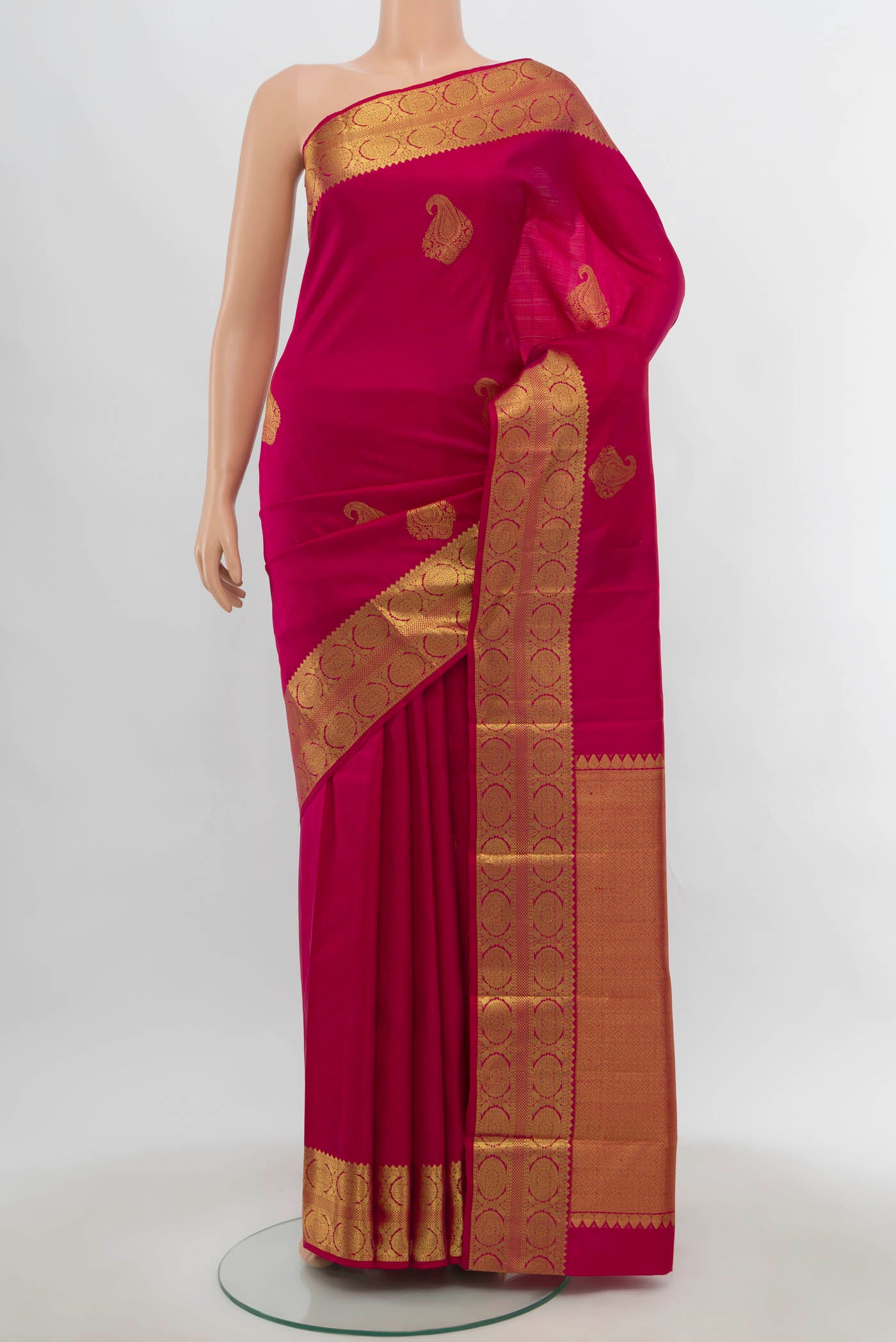 Dark Pink Kanchipuram Silk Saree with Zari Butta on the body and Zari Border.  displayed on a mannequin