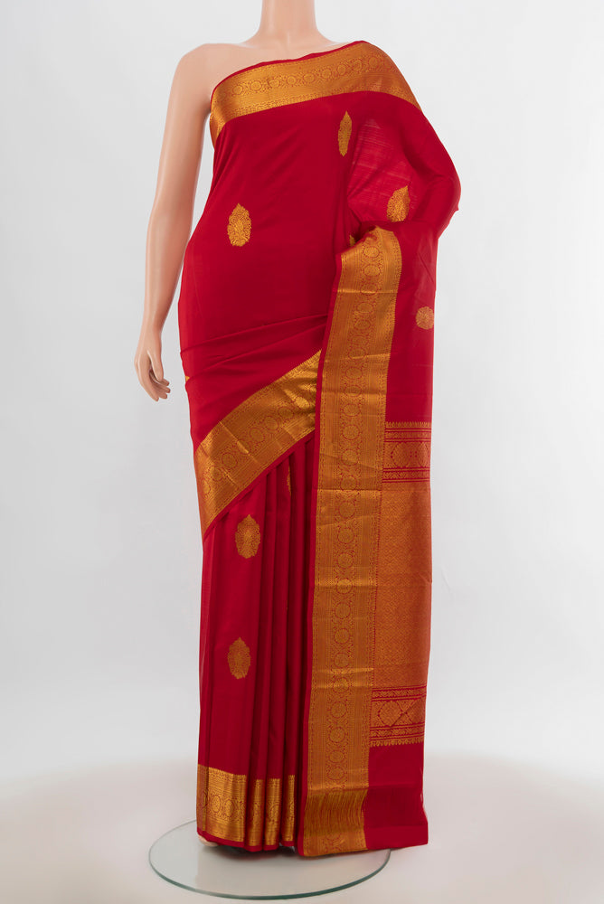 Red Kanchipuram Silk Saree with Zari Butta on the body and Silk Border.  displayed on a mannequin