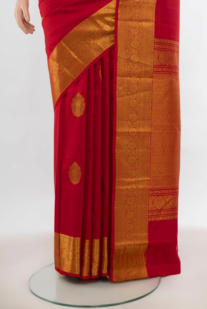 Pleats and pallu of Red Kanchipuram Silk Saree with Zari Butta on the body and Silk Border. 